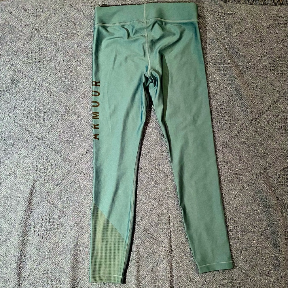 Under Armour HeatGear compression athletic tights. Light teal color. Size Large.